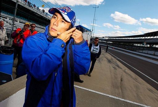 Takuma Sato of Japan prepares to get in his car during Indianapolis 500 practice on May 12, 2013 in Indianapolis