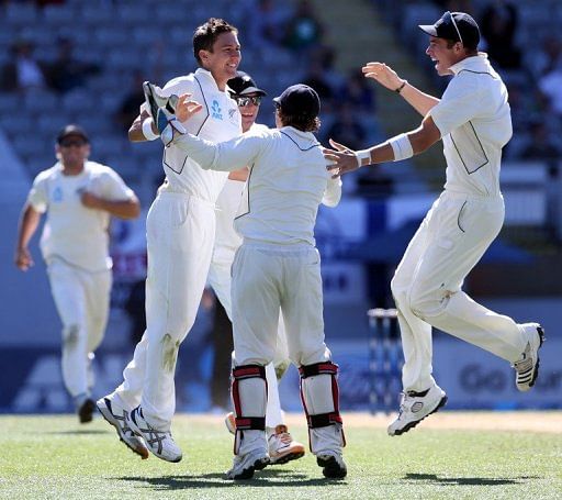 Trent Boult (2nd L) celebrates with teammates during day five of the Test against England on March 26, 2013
