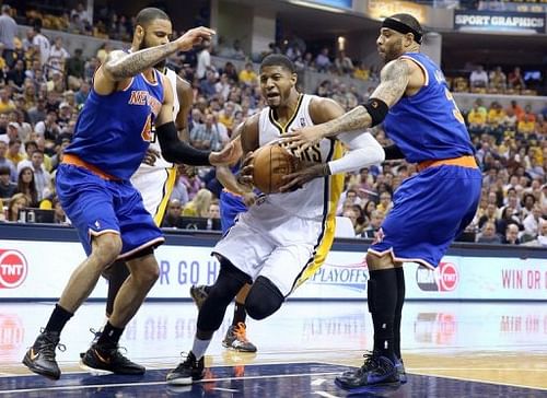 New York Knicks' Tyson Chandler (L) and Kenyon Martin try to block Paul George (C) of the Indiana Pacers on May 14, 2013