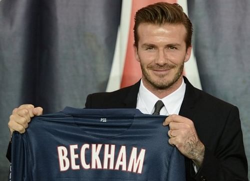David Beckham poses with his jersey at the Parc des Princes stadium in Paris on January 31, 2013