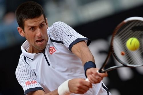 Novak Djokovic returns the ball to Alexandr Dolgopolov during their Rome Masters tennis match on May 16, 2013