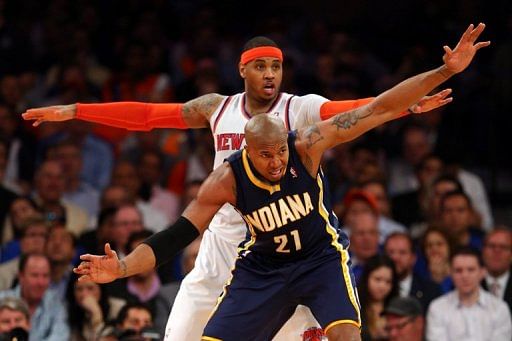 Carmelo Anthony of the New York Knicks is guarded by David West of the Indiana Pacers during Game Five on May 16, 2013