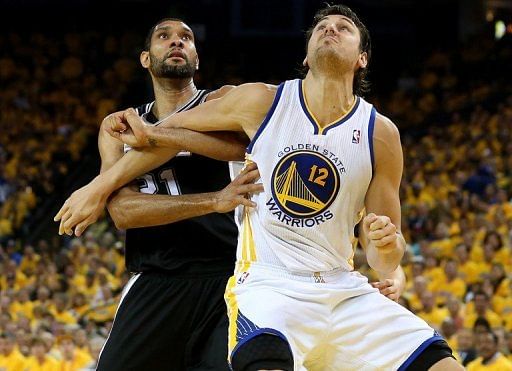 Andrew Bogut of the Golden State Warriors fights for position against Tim Duncan of the San Antonio Spurs, May 16, 2013