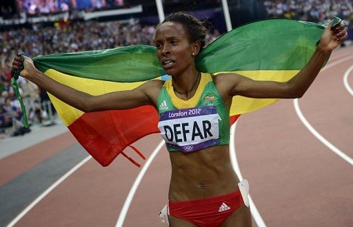 Ethiopia&#039;s Meseret Defar waves her national flag after winning gold in the 5000m at the London Olympic Games  2012