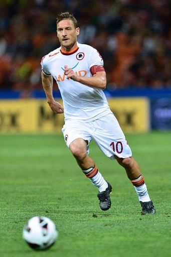 AS Roma&#039;s forward Francesco Totti runs for the ball in the match against AC Milan in Milan  on May 12, 2013
