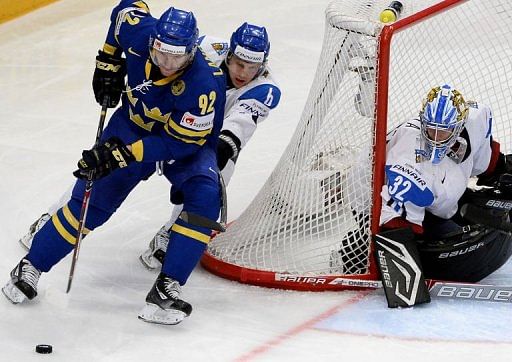 Sweden&#039;s forward Gabriel Landeskog (L) tries to score on Finland&#039;s goalkeeper Antti Raanta on May 18, 2013 in Stockholm
