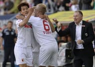 L-R: Augsburg's Dong-Won Ji, Kevin Vogt and manager Stefan Reuter celebrate in Augsburg, on May 18, 2013