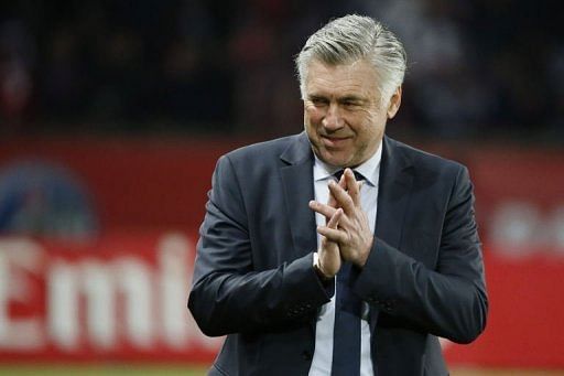PSG coach Carlo Ancelotti claps during the French L1 match between PSG and Brest on May 18, 2013 in Paris