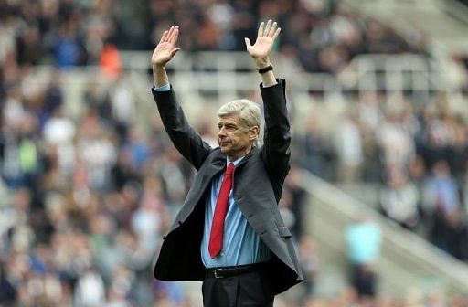 Arsenal manager Arsene Wenger gestures to the fans in Newcastle Upon Tyne on May 19, 2013