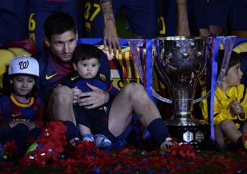 Barcelona's Lionel Messi holds his son Thiago during a ceremony at the Camp Nou stadium in Barcelona on May 19, 2013 Barcelona's Lionel Messi holds his son Thiago during a ceremony at the Camp Nou stadium in Barcelona on May 19, 2013