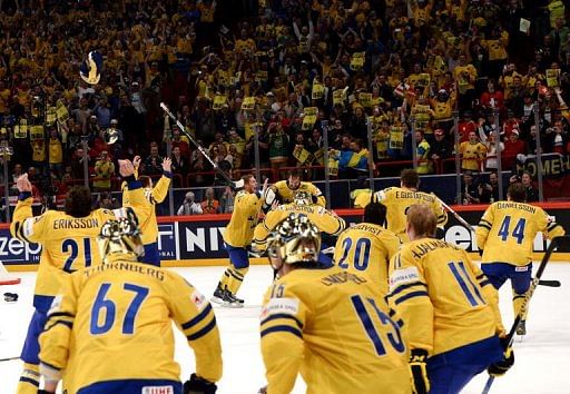 Sweden&#039;s players react after winning the IIHF Ice Hockey World Championship final on May 19, 2013 in Stockholm