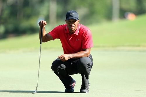 Tiger Woods lines up a birdie putt at TPC Sawgrass on May 12, 2013 in Ponte Vedra Beach, Florida