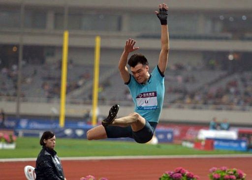 Li Jinzhe of China makes the winning jump in the men&#039;s long jump event in Shanghai on May 18, 2013