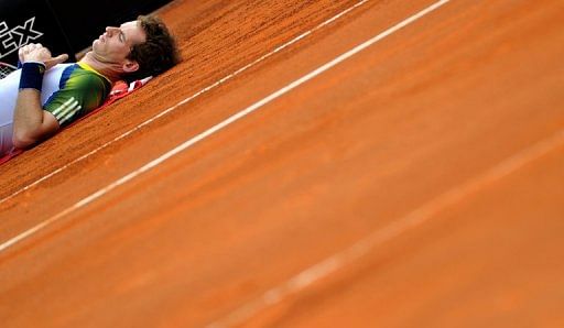 Andy Murray lies on the court as he receives treatment during the ATP Rome Open tennis tournament on May 15, 2013