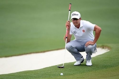 Adam Scott lines up a putt with his broom-handle putter at Augusta National Golf Club on April 14, 2013