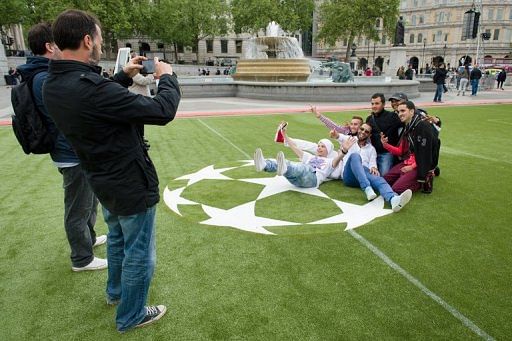 People take photos in a &#039;football fan zone&#039; at Trafalgar Square in London, on May 22, 2013