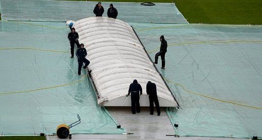 Groundstaff wait for the rain to stop before play can start during the second Test match at Headingley, on May 24, 2013