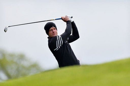 English golfer Luke Donald plays his approach shot to the 1st green in Surrey, England, on May 24, 2013