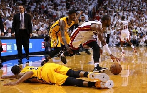 Miami Heat's Dwyane Wade reaches for a loose ball in the game against Indiana Pacers on May 24, 2013 in Miami, Florida