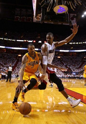George Hill of the Indiana Pacers battles Chris Bosh of the Miami Heat on May 24, 2013 in Miami, Florida