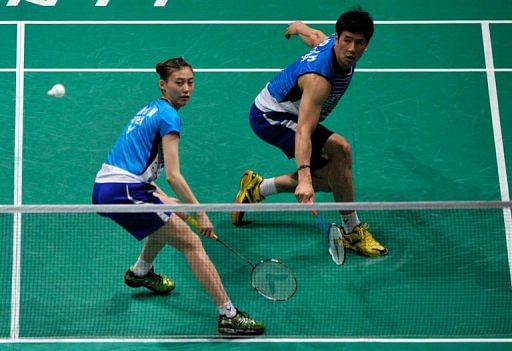 Ko Sung Hyun (right) of South Korea hits a return during the mixed doubles semi-final  in Kuala Lumpur on May 25, 2013