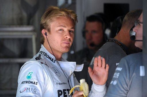 Nico Rosberg eats a banana during the first practice session at the Circuit de Monaco in Monte Carlo on May 23, 2013
