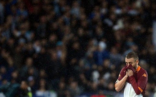 AS Roma midfielder Daniele De Rossi wipes his face during the match against Lazio on November 11, 2012 in Rome