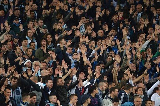 Lazio&#039; fans cheer their team during the match against AS Roma Rome on April 8, 2013 at the Olympic stadium in Rome