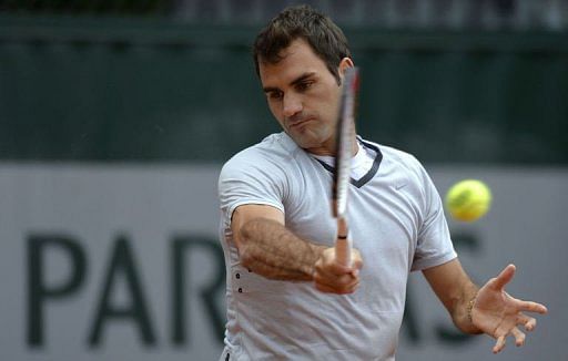 Roger Federer practices on the eve of the French Open at the Roland Garros stadium in Paris, on May 25,  2013