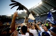 Lazio's players hold the trophy with an eagle, the team's mascot, to celebrate victory on May 26, 2013 in Rome