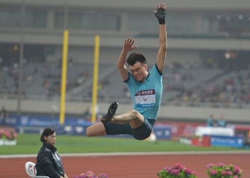 Li Jinzhe makes the winning jump in the men's long jump event in Shanghai, on May 18, 2013