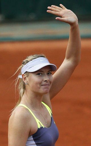 Russia&#039;s Maria Sharapova celebrates after winning her first round match on May 27, 2013 in Paris