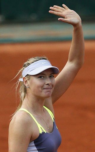 Russia's Maria Sharapova celebrates after winning her first round match on May 27, 2013 in Paris