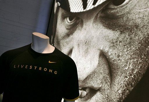 A Nike Livestrong shirt and poster of Lance Armstrong are displayed in the window at a NikeTown store on May 15, 2009