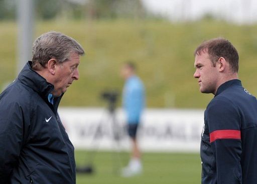 England manager Roy Hodgson (L) talks to striker Wayne Rooney during a team training session in England on May 27, 2013