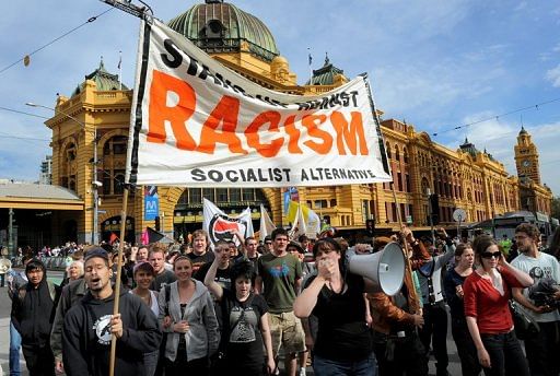 People hold up banners as they hold an anti-racism protest in Melbourne, on April 9, 2010