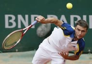 France's Gilles Simon hits a shot to Uruguay's Pablo Cuevas during their French Open match in Paris, on May 29, 2013