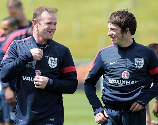 England striker Wayne Rooney (L) laughs with teammate Leighton Baines in Staffordshire, England on May 27, 2013