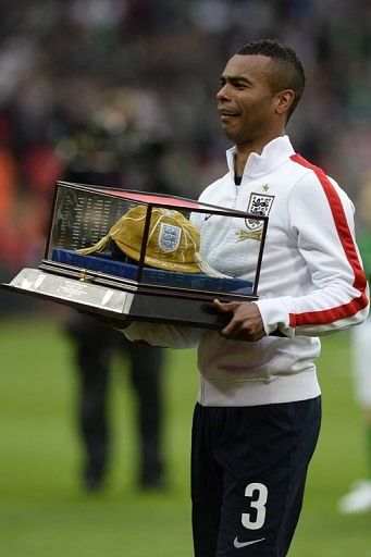Ashley Cole carries his golden cap ahead of the football friendly against the Republic of Ireland on May 29, 2013