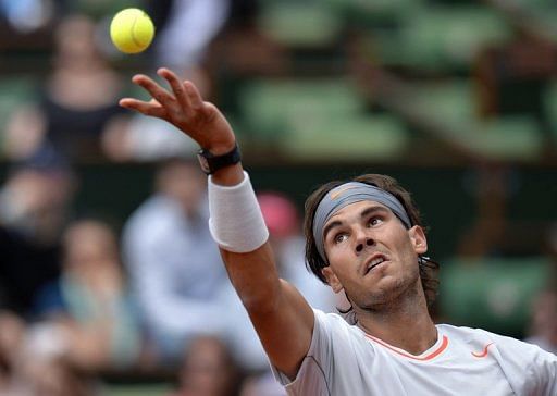 Rafael Nadal serves to Daniel Brands during their French Open match at Roland Garros on May 27,  2013