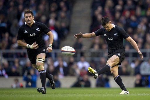 The All Blacks&#039; Dan Carter (R) kicks the ball alongside Richie McCaw during a match in England on December 1, 2012