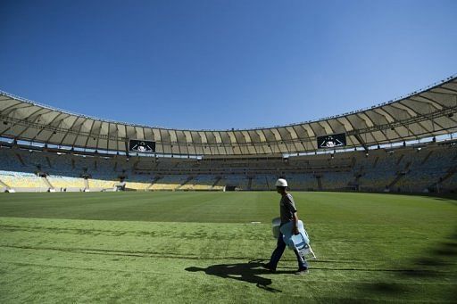 A worker walks across the pitch at the Maracana stadium in Rio de Janeiro, Brazil on May 15, 2013