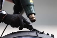 Pirelli technician works on a tyre during practice for the European Formula One Grand Prix at the Valencia Street Circuit on July 24, 2011, in Valencia, Spain. (Photo by Clive Rose/Getty Images)