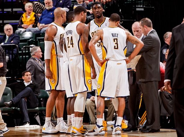 : Indiana Pacers players, from left, David West #21, Paul George #24, Roy Hibbert #55 and George Hill #3 speak with head coach Frank Vogel during a game against the Toronto Raptors on February 8, 2013 at Bankers Life Fieldhouse in Indianapolis, Indiana. (Getty Images)
