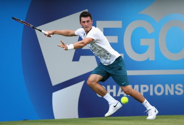 Tennis: Tomic bows out at Queen's as father watches on