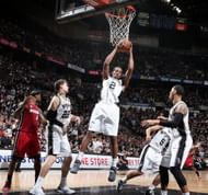 Kawhi Leonard #2 of the San Antonio Spurs rebounds the ball while playing against the Miami Heat during Game Three of the 2013 NBA Finals on June 11, 2013 at the AT&T Center in San Antonio, Texas.
