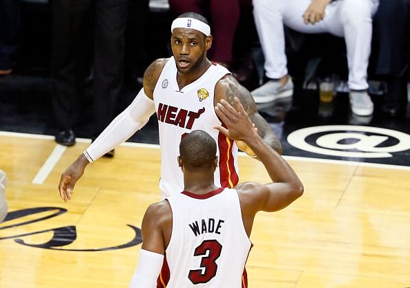 LeBron James #6 and Dwyane Wade #3 of the Miami Heat celebrate in the second half while taking on the San Antonio Spurs during Game Seven of the 2013 NBA Finals at AmericanAirlines Arena on June 20, 2013 in Miami, Florida. (Getty Images)