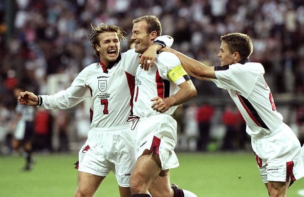 England captain Alan Shearer celebrates with team mates David Beckham and Michael Owen after scoring from the penalty spot 