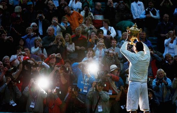 Rafael Nadal of Spain poses for photographers with the Championship trophy after winning the men&#039;s singles Final match against Roger Federer of Switzerland on day thirteen of the Wimbledon Lawn Tennis Championships at the All England Lawn Tennis and Croquet Club on July 6, 2008 in London, England.  (Photo by Pool/Getty Images)