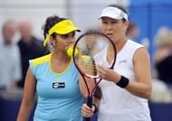 Indias Sania Mirza (L) talks tactics during her women's doubles match with Liezel Huber of the US (R) against Britain's Heather Watson and Croatia's Darija Jurak on the fourth day of the AEGON International tennis tournament in Eastbourne, southern England on June 18, 2013. (Getty Images)